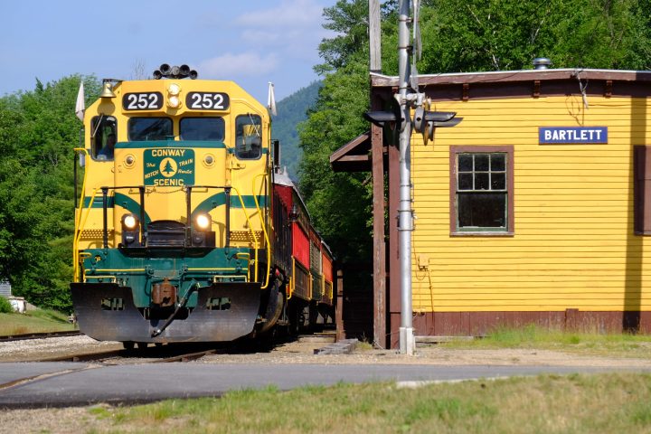 a train is parked on the side of the road