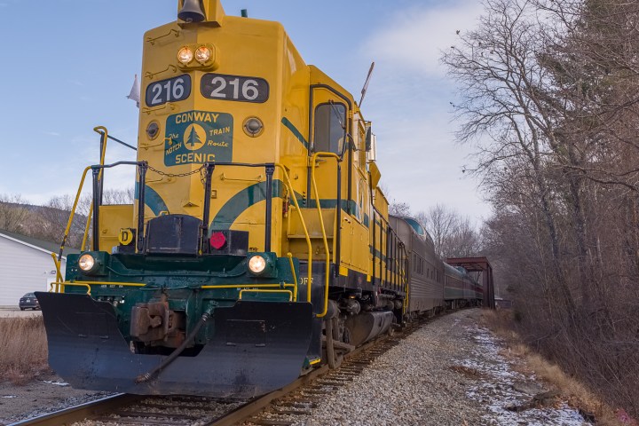 a train is parked on a dirt track