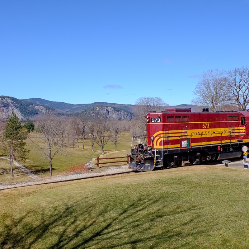 a train traveling down a dirt road