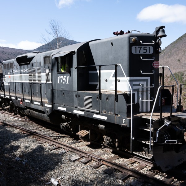 a train sitting on the side of a mountain