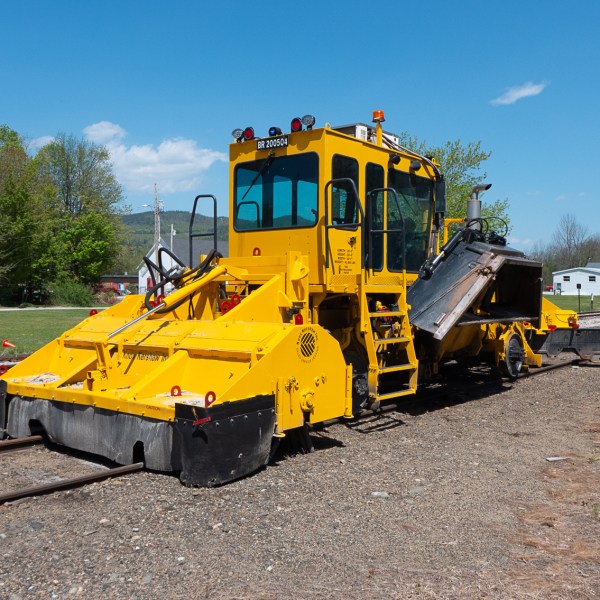 a truck driving down a dirt road