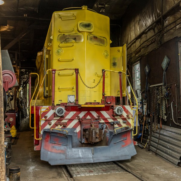 a train is parked on the side of a building