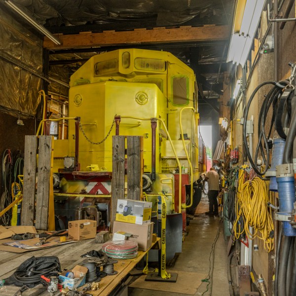 a train is parked on the side of a building