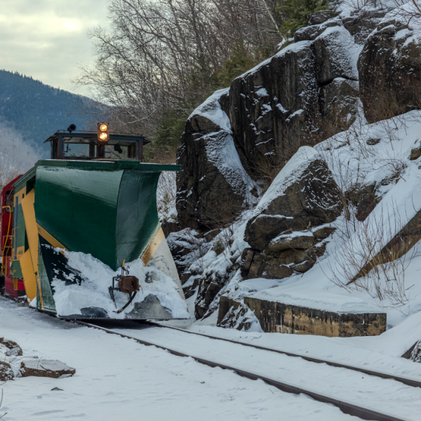 a man riding skis down a snow covered mountain
