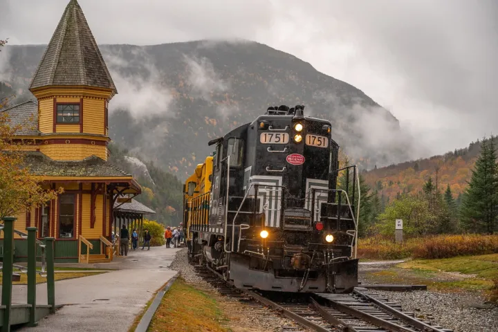 a train on a track with smoke coming out of it