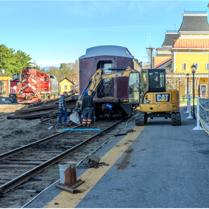 a train is parked on the side of a building