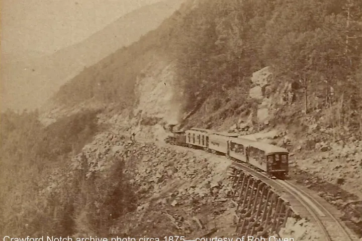 a vintage photo of a train on a steel track