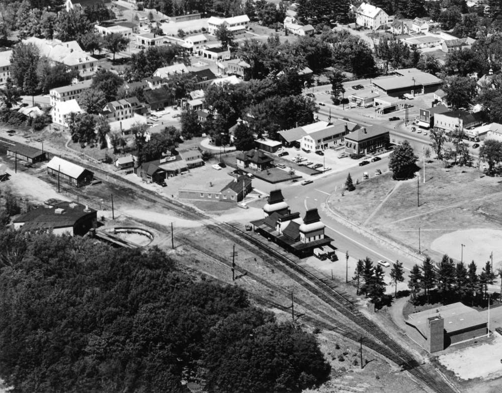 Aerial view of a small town with buildings and train tracks.